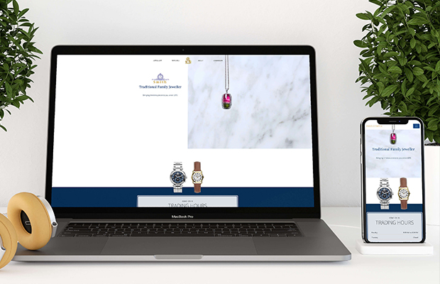 A deer stands in front of a sunset on the beach