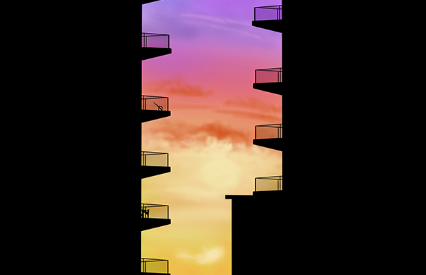 A building block silhoutetted against a sunset.