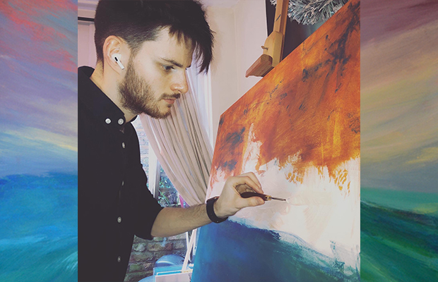 Sam painting on a canvas